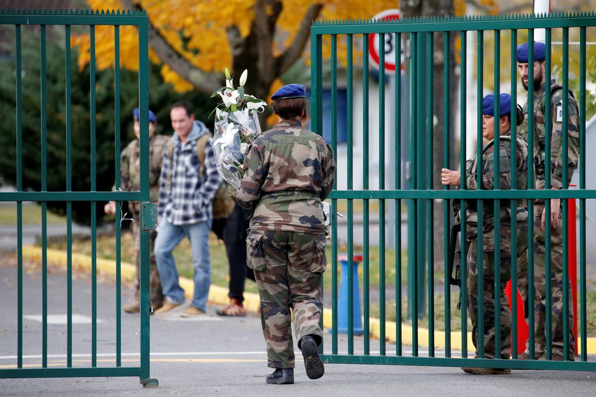 A French soldier arrives with flowers at the 5th Combat Helicopter Regiment (5th RHC) base in Uzein near Pau, France, November 26, 2019. Thirteen French soldiers were killed in Mali when their helicopters collided at low altitude as they swooped in to support ground forces engaged in combat with ISIS extremists. REUTERS/Regis Duvignau