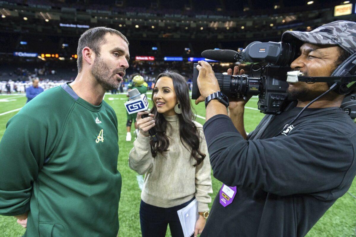 Acadiana head coach Matt McCullough (L) speaks with Carley McCord (C) following a win over the Destrehan in the State Division 5A Championship football game in Lafayette, La., on Dec. 14, 2019. (Scott Clause/The Daily Advertiser via AP)