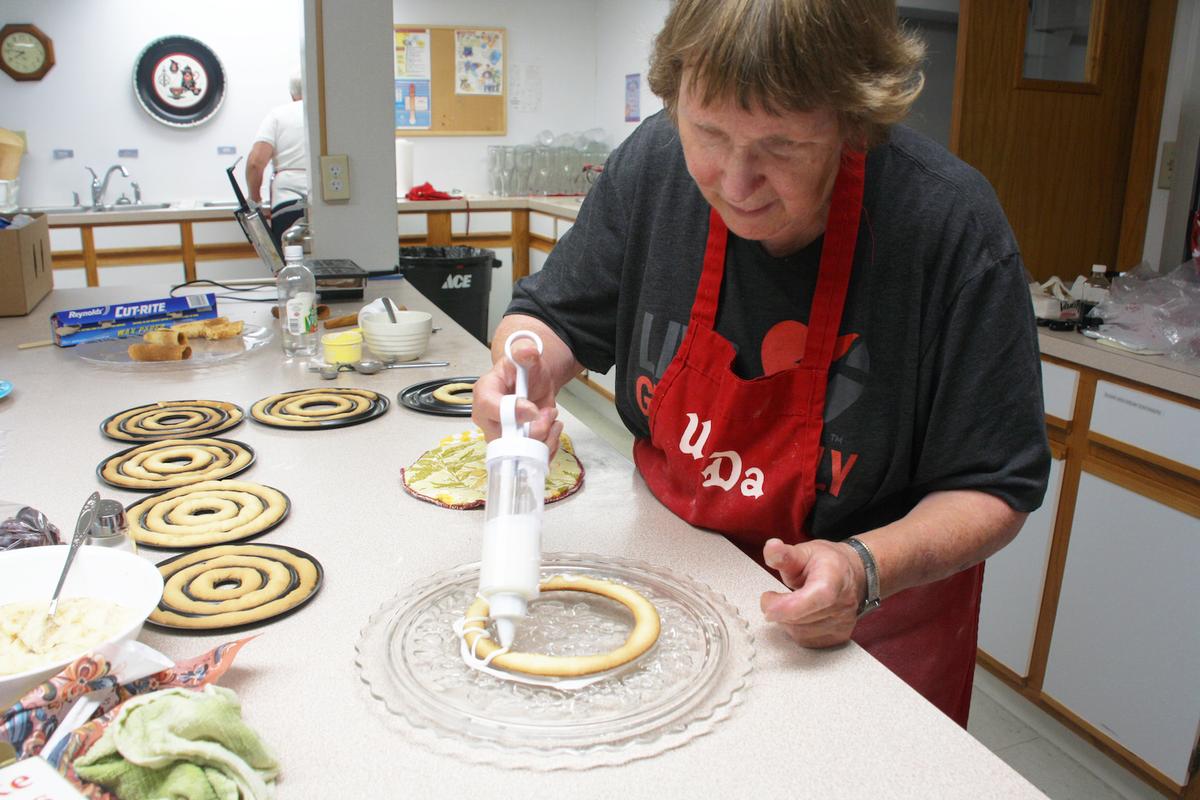 Making kransekake, traditionally served on special occasions such as weddings or Christmas, is a joint effort. (Courtney Duke Graves)