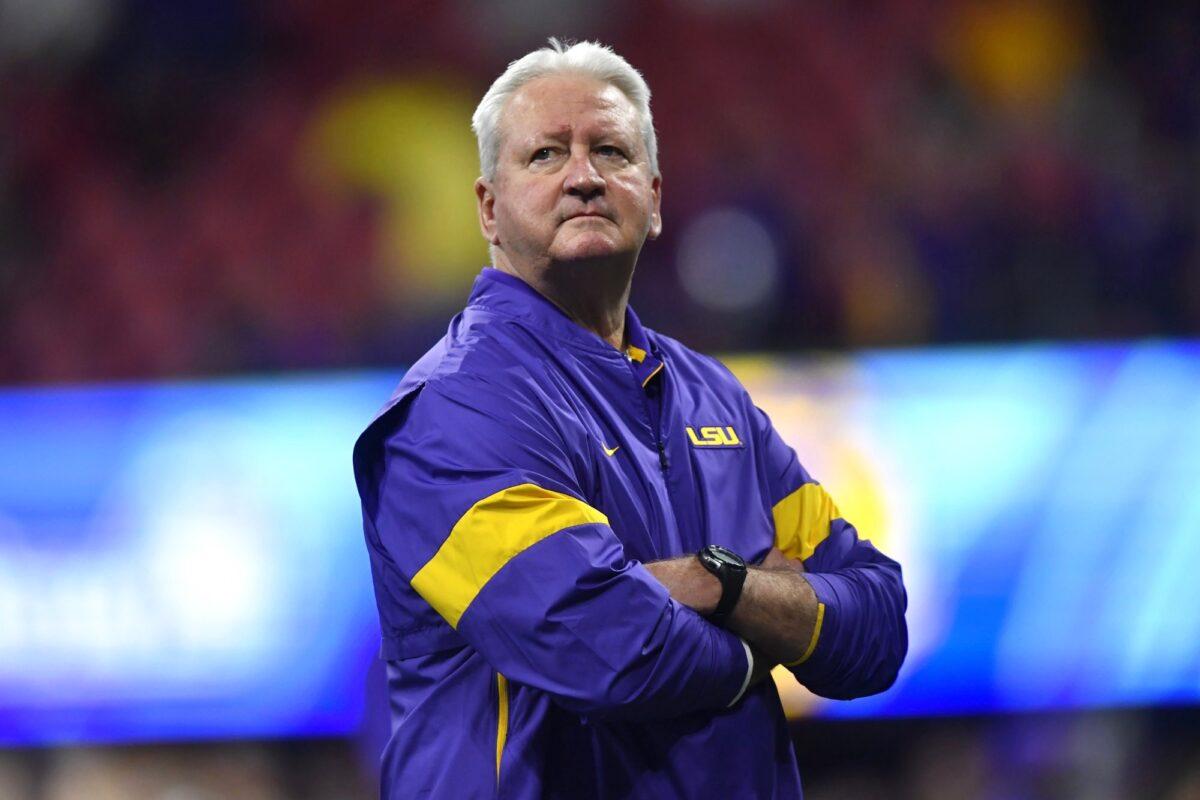 LSU Offensive Coordinator Steve Ensminger watches teams warm up before the first half of the Peach Bowl NCAA semifinal college football playoff game between LSU and Oklahoma, in Atlanta, Ga., on Dec. 28, 2019. (John Amis/AP Photo)