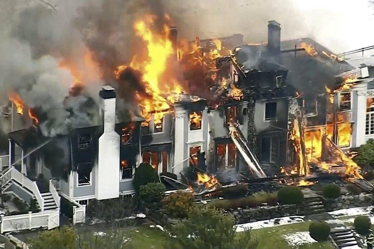A mansion ablaze, in Concord, Mass., on Dec. 27, 2019. (WCVB-TV via AP)
