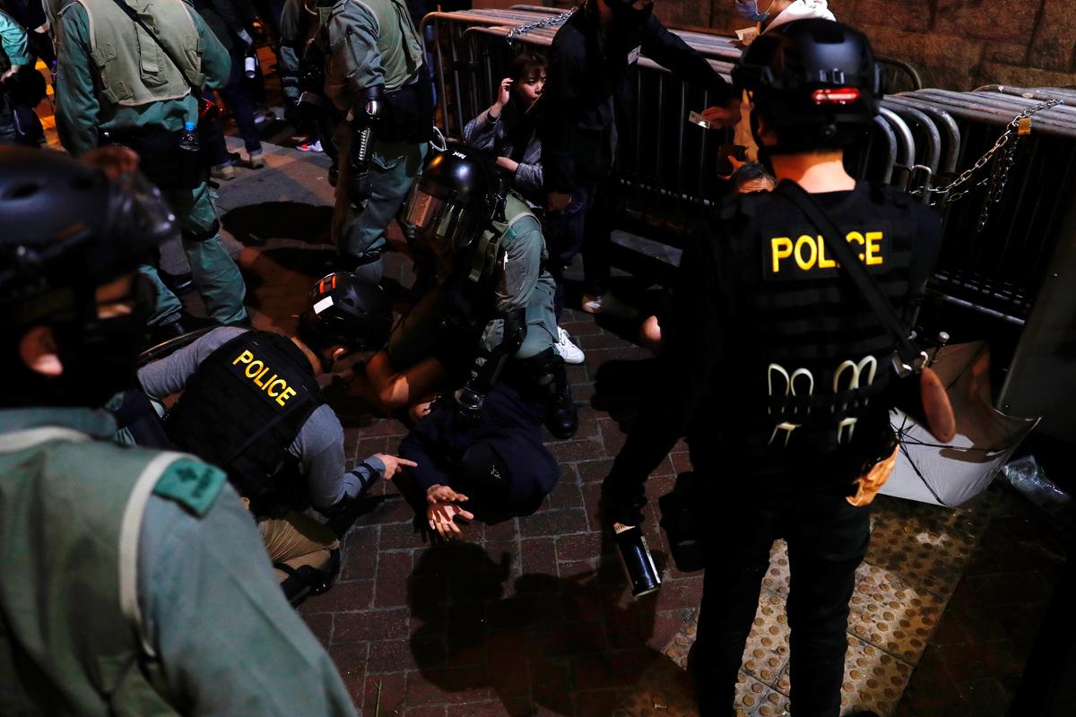 Riot police officers detain an anti-government protester during a demonstration on New Year's Eve outside Mong Kok police station in Hong Kong on Dec. 31, 2019. (Tyrone Siu/Reuters)