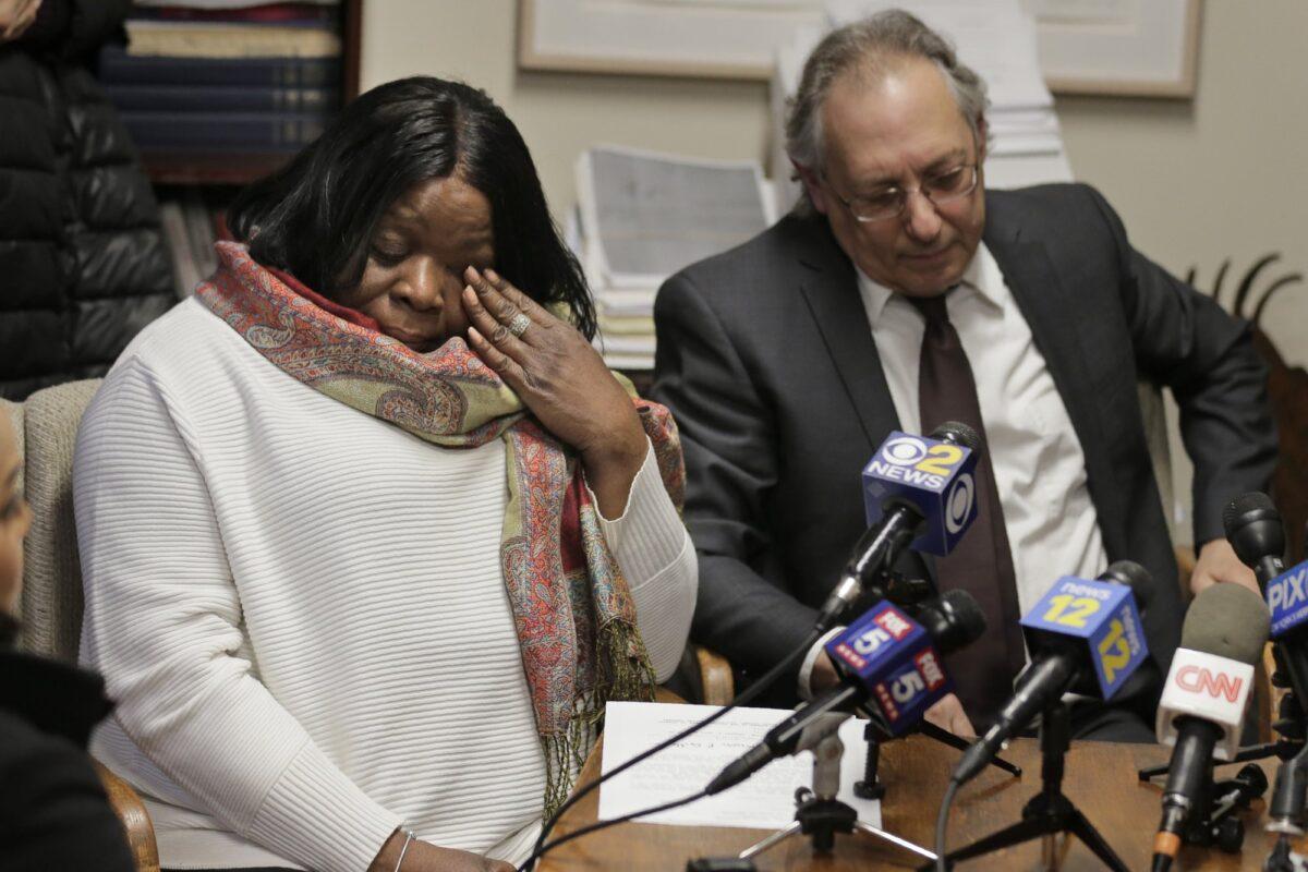 Kim Thomas (L), mother of Grafton Thomas, the man accused of stabbing five people at a Hanukkah celebration, reacts during a news conference as attorney Michael Sussman speaks in Goshen, N.Y., on Dec. 30, 2019. (Seth Wenig/AP)