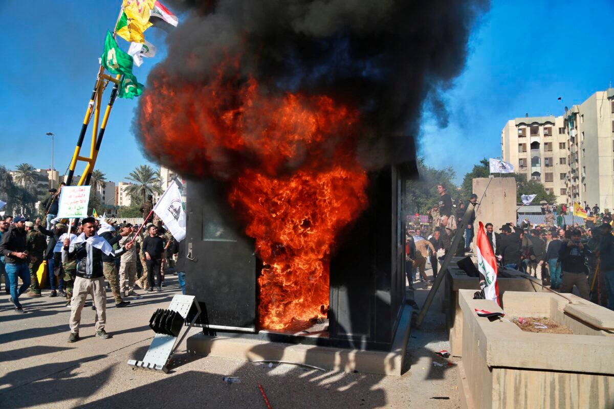 Protesters burn property in front of the U.S. embassy compound, in Baghdad, Iraq, on Dec. 31, 2019. (Khalid Mohammed/AP Photo)