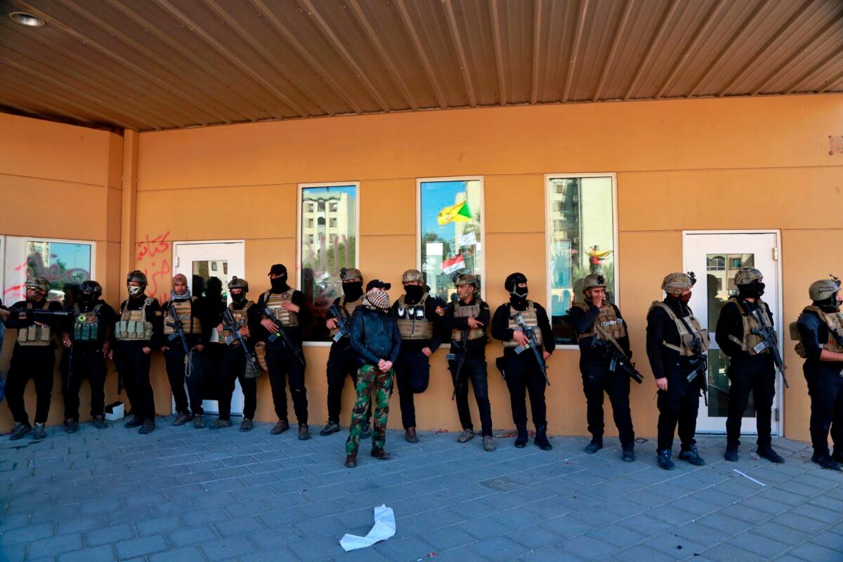 Iraqi security forces stand guard in front of the U.S. embassy in Baghdad, Iraq on Dec. 31, 2019. (Khalid Mohammed/AP Photo)