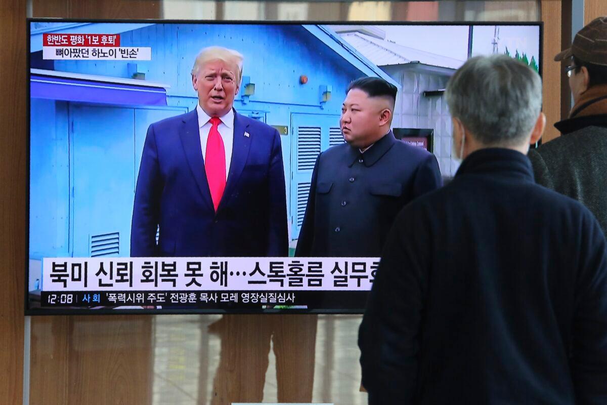 People watch a TV screen showing a file image of North Korean leader Kim Jong Un and U.S. President Donald Trump during a news program at the Seoul Railway Station in Seoul, South Korea, on Dec. 31, 2019. (Ahn Young-joon/AP Photo)