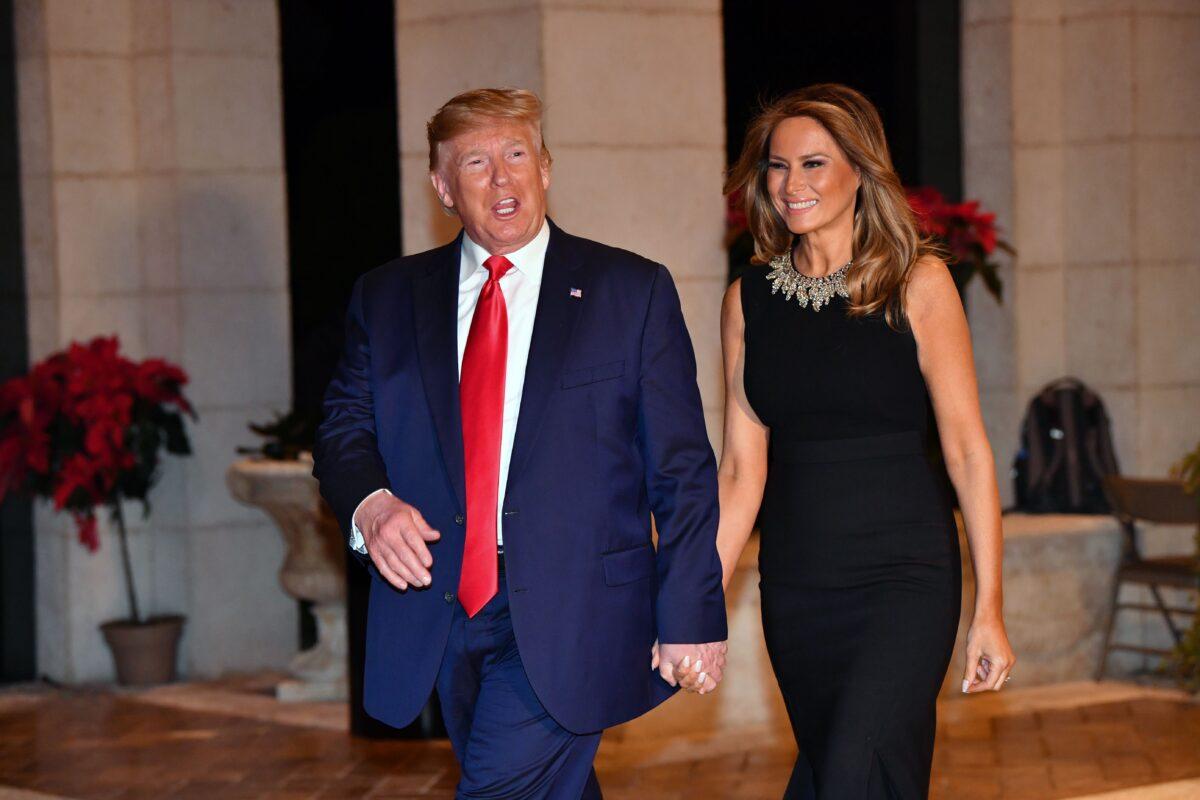 US President Donald Trump and First Lady Melania Trump arrive for a Christmas Eve dinner with his family at Mar-A-Lago in Palm Beach, Florida on December 24, 2019. (Photo by Nicholas Kamm / AFP) (Photo by NICHOLAS KAMM/AFP via Getty Images)