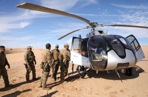 Border Patrol BORSTAR agents load an injured man into a waiting helicopter in the Imperial Sand Dunes, Calif., on Nov. 30, 2019. (Charlotte Cuthbertson/The Epoch Times)