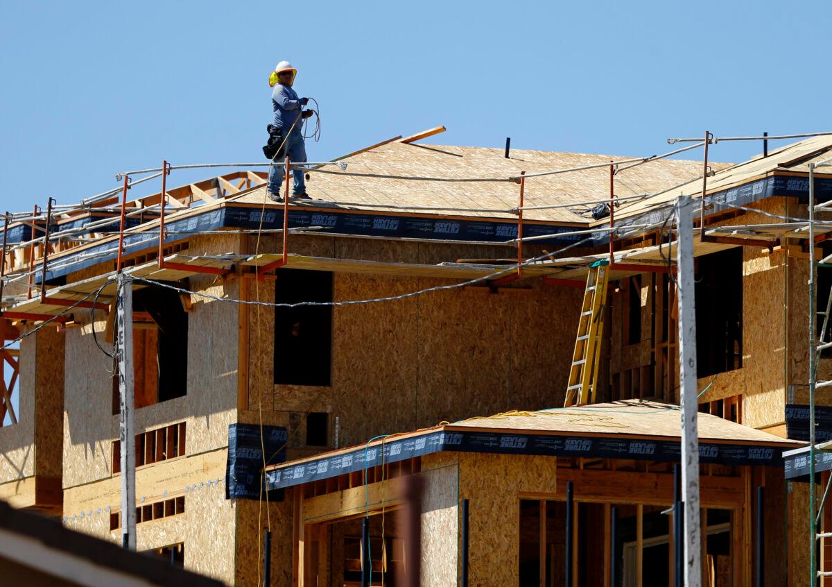 A worker walks on the roof of a new home under construction in Carlsbad, Calif., on Sept. 22, 2014. (Reuters/Mike Blake/File Photo)