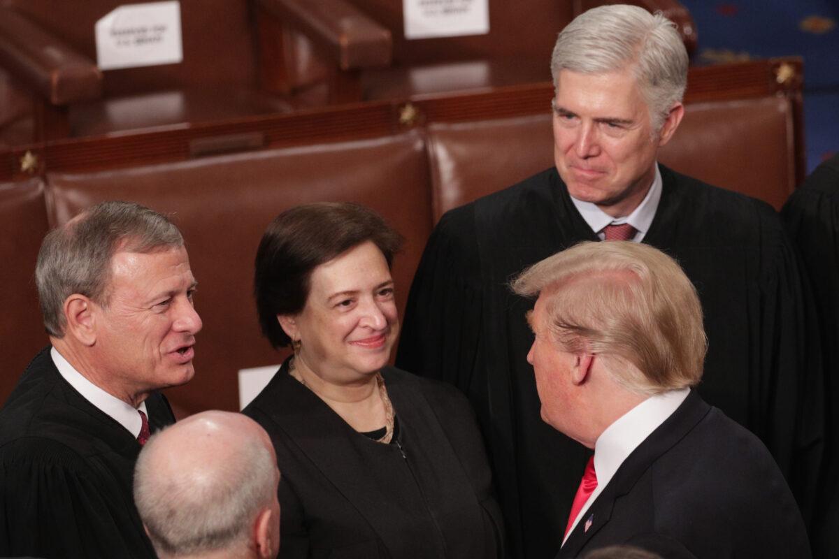President Donald Trump greets Supreme Court Justices John Roberts, Elena Kagan, and Neil Gorsuch after the State of the Union address in the chamber of the U.S. House of Representatives at the U.S. Capitol Building in Washington on Feb. 5, 2019. (Alex Wong/Getty Images)