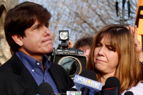Patti Blagojevich (R), wife of disgraced former Illinois Governor Rod Blagojevich, looks at him while he pauses at a news conference outside his home in Chicago on March 14, 2012. (Frank Polich/Getty Images)