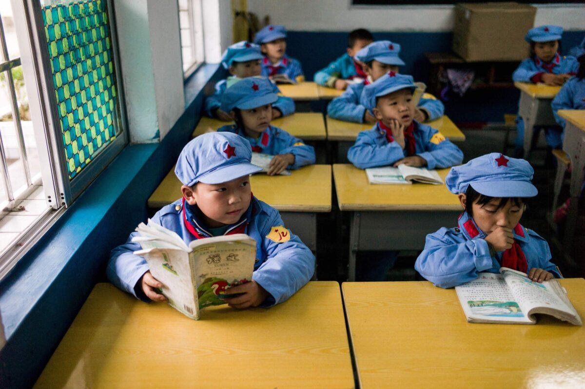 Students read in their classroom in the Yang Dezhi "Red Army" elementary school in Wenshui, Xishui County in Guizhou Province, China, on Nov. 7, 2016. In 2008, Yang Dezhi was designated a “Red Army primary school”—funded by China's “red nobility” of revolution-era communist commanders and their families, one of many such institutions established across the country. Such schools are an extreme example of the “patriotic education” China's Communist Party promotes to boost its legitimacy—but critics condemn it as little more than brainwashing. (Fred Dufour/AFP via Getty Images)
