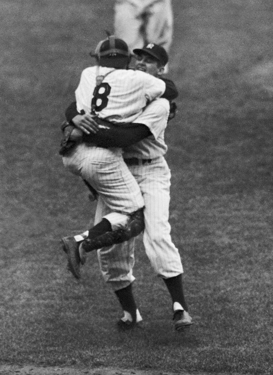 New York Yankees catcher Yogi Berra leaps into the arms of pitcher Don Larsen after Larsen struck out the last Brooklyn Dodgers batter to complete his perfect game during Game 5 of the World Series in New York on Oct. 8, 1956. (AP Photo/File)