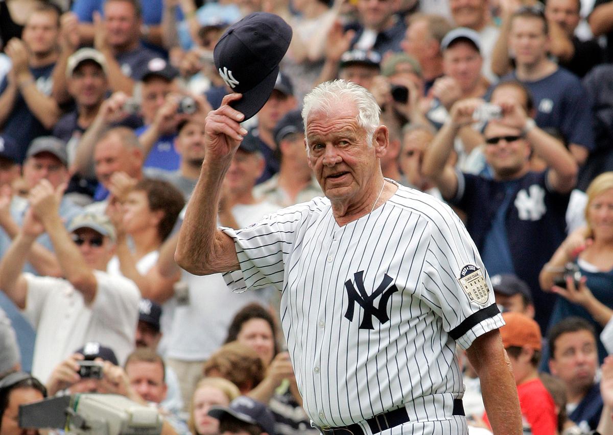 Former New York Yankees player Don Larsen tips his hat to fans during introduction ceremonies before an old-timers baseball game at Yankee Stadium in New York, Aug. 2, 2008. (AP Photo/Ed Betz)