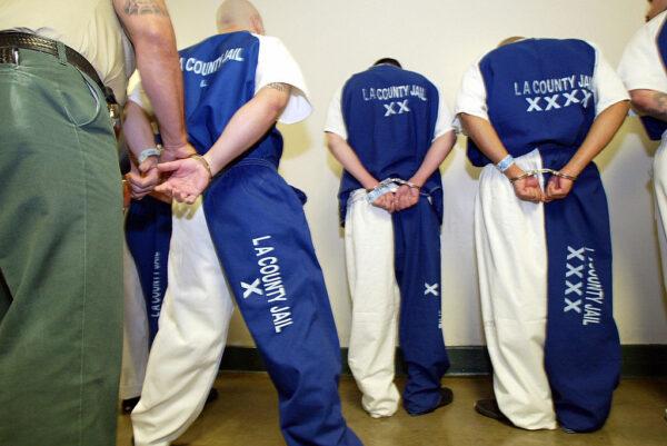 A sheriff's deputy checks the handcuffs on inmates at the Los Angeles Men's Central Jail in downtown Los Angeles, May 19, 2004. (Robyn Beck/AFP via Getty Images)