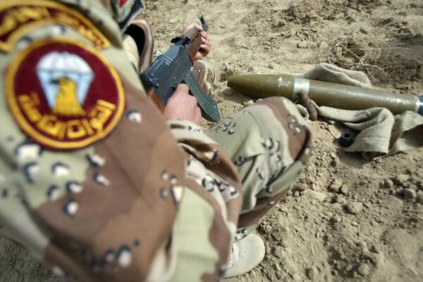 An Iraqi army soldier inspects a Katyusha rocket found at a field in the vicinity of the Shiite shrine city of Karbala, central iraq, on March 21, 2008. (MOHAMMED SAWAF/AFP via Getty Images)