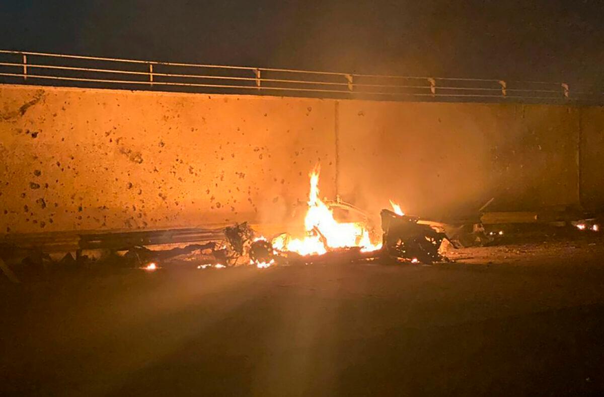 This photo released by the Iraqi Prime Minister Press Office shows a burning vehicle at the Baghdad International Airport following an airstrike, in Baghdad, Iraq, early Jan. 3, 2020. The Pentagon said Thursday that the U.S. military has killed Gen. Qassem Soleimani, the head of Iran's elite Quds Force, at the direction of President Donald Trump. (Iraqi Prime Minister Press Office via AP)