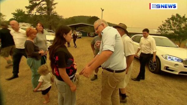 Australia's Prime Minister Scott Morrison attempts to shake a resident's hand during a visit to the bushfire-stricken town of Cobargo, Australia, Jan. 2, 2020 in this still image taken from video. (Nine Network/via REUTERS TV)