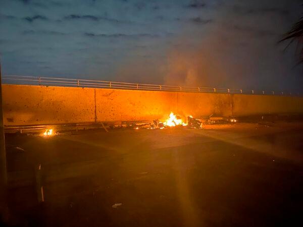 This photo released by the Iraqi Prime Minister Press Office shows a burning vehicle at the Baghdad International Airport following an airstrike, in Baghdad, Iraq, early Jan. 3, 2020. (Iraqi Prime Minister Press Office via AP)