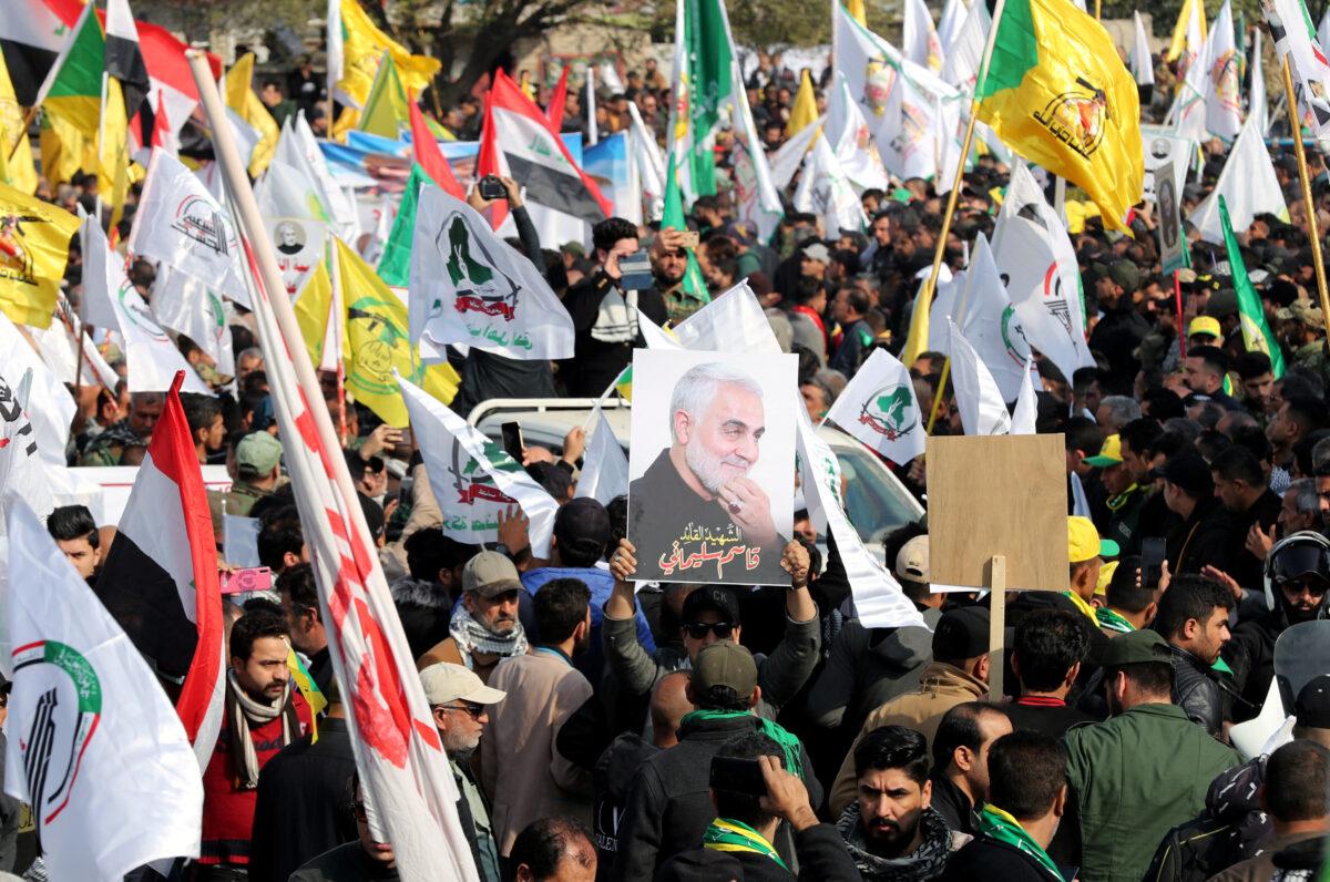 Mourners react as they attend the funeral of the Iranian Major-General Qassem Soleimani, top commander of the elite Quds Force of the Revolutionary Guards, and the Iraqi militia commander Abu Mahdi al-Muhandis, who were killed in an airstrike at Baghdad airport, in Baghdad, Iraq, on Jan. 4, 2020. (Thaier al-Sudani/Reuters)