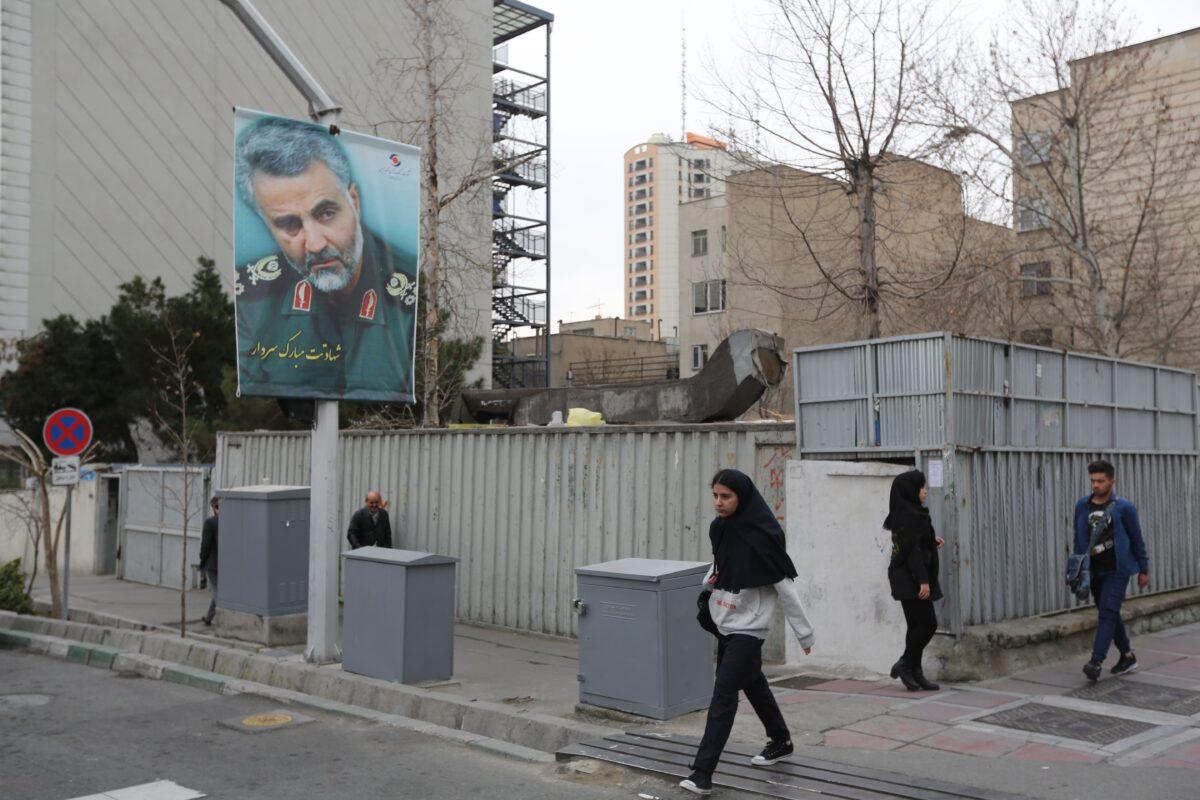 Pedestrians walk past a portrait of slain Iranian military commander Qassem Soleimani on a main road in the Iranian capital Tehran on Jan. 4, 2020. (Atta Kenare/AFP via Getty Images)