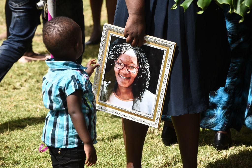 A boy touches the portrait of the victim of an Al-Shabaab terror attack during her burial ceremony in Nakuru, Kenya, on Jan 25, 2019. At least 21 people were killed in the attack on the Dusit hotel complex in Nairobi on Jan. 15, 2019, which ended after an almost 20-hour siege in which hundreds of civilians were rescued, and the five attackers killed. (Suleiman Mbatiah/AFP/Getty Images)