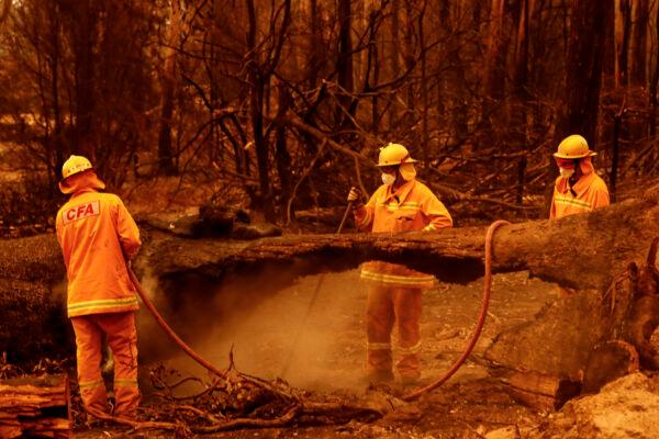 Fire crews put out spot fires in Sarsfield, Australia, on Jan. 4, 2020. (Darrian Traynor/Getty Images)