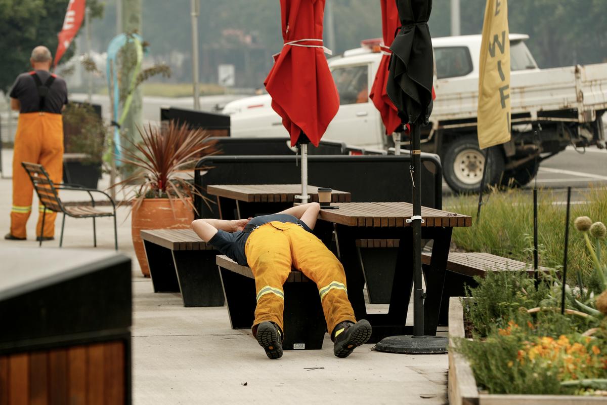 An exhausted firefighter rests outside a café in Cann River, Australia, on Jan. 6, 2020. (©Getty Images | <a href="https://www.gettyimages.com/detail/news-photo/tired-firefighter-rests-outside-a-cafe-on-january-06-2020-news-photo/1197771646?adppopup=true">Darrian Traynor</a>)