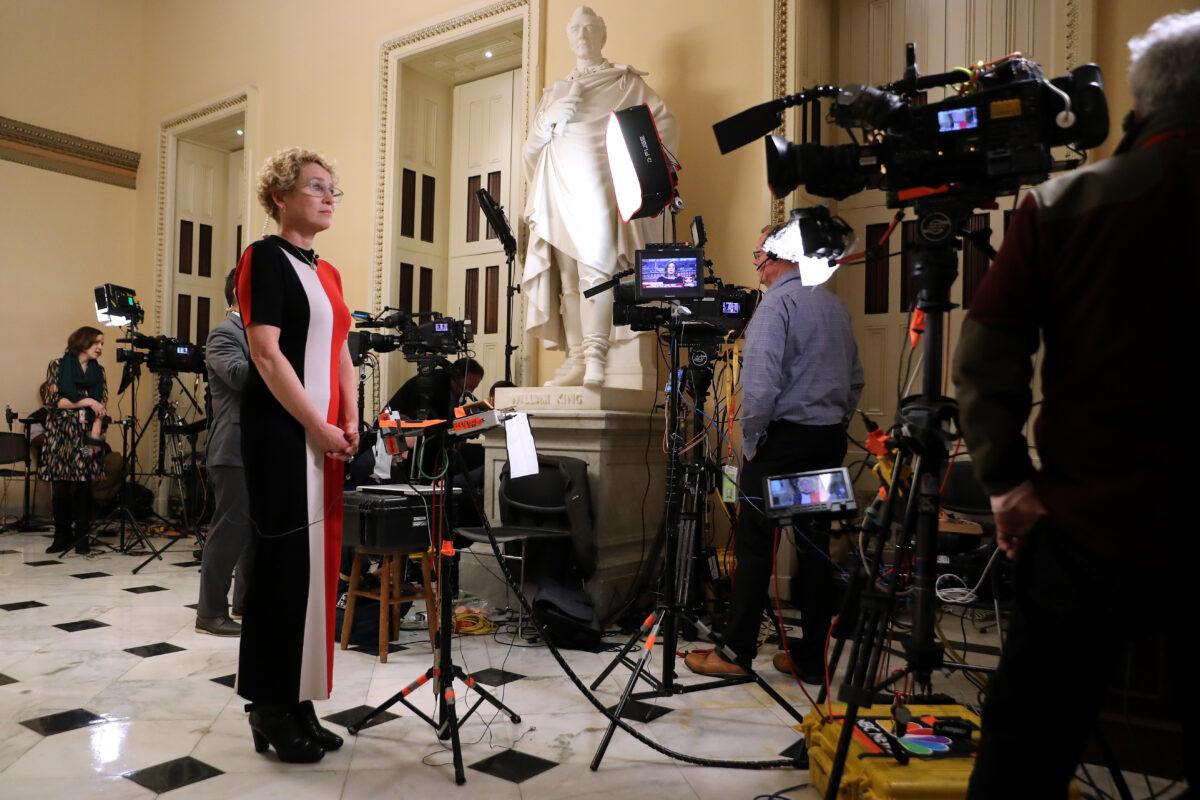 Rep. Chrissy Houlahan (D-Penn.) prepares to be interviewed on television just outside the House Chamber at the U.S. Capitol in Washington on Dec. 17, 2019. (Chip Somodevilla/Getty Images)