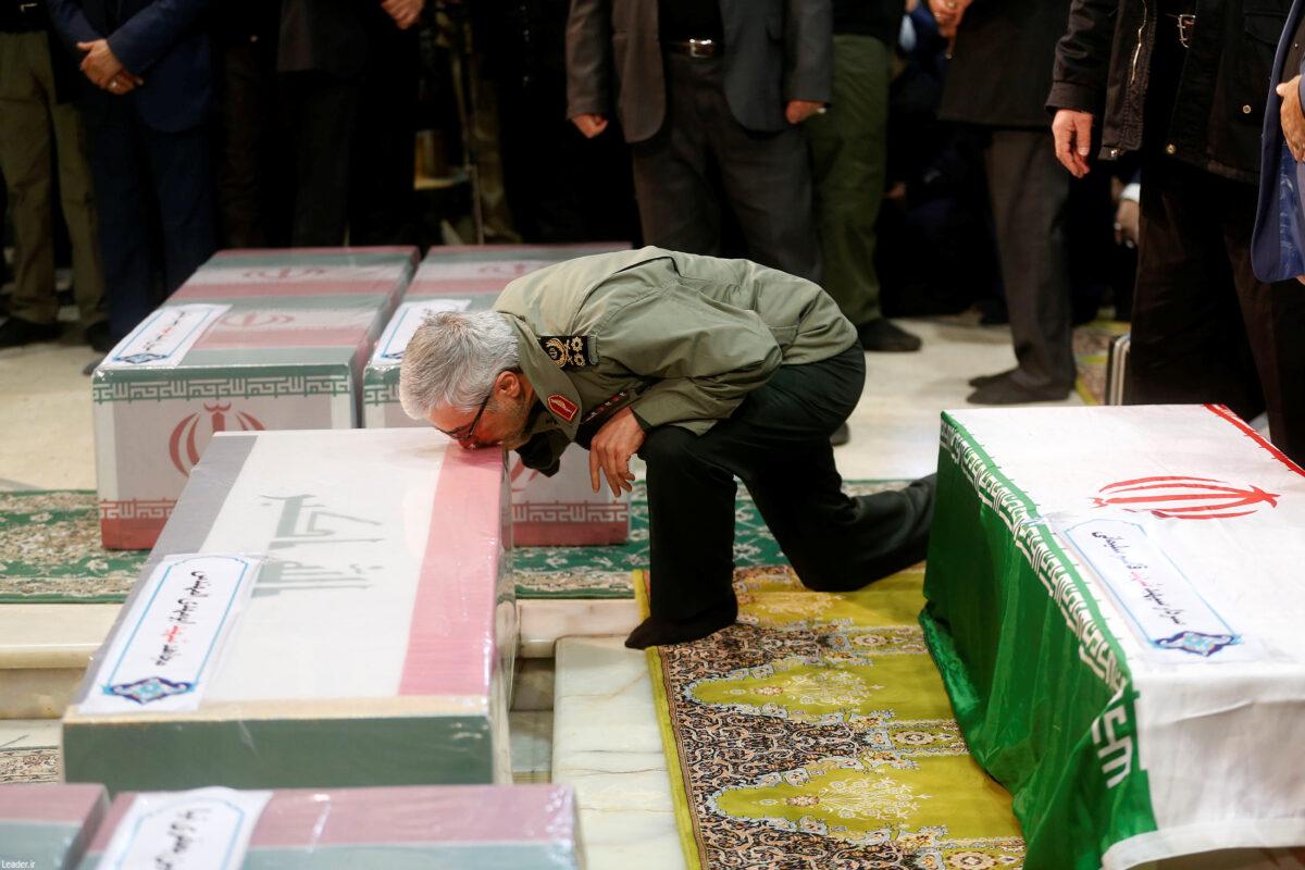 Brigadier-General Esmail Qaani, the newly appointed commander of the country's Quds Force, kisses a coffin during the funeral prayer over the coffins of Iranian Maj. Gen. Qassem Soleimani, head of the elite Quds Force and Iraqi militia commander Abu Mahdi al-Muhandis who were killed in an airstrike at Baghdad airport, in Tehran, on Iran on Jan. 6, 2020. (Official Khamenei website/Handout via Reuters)