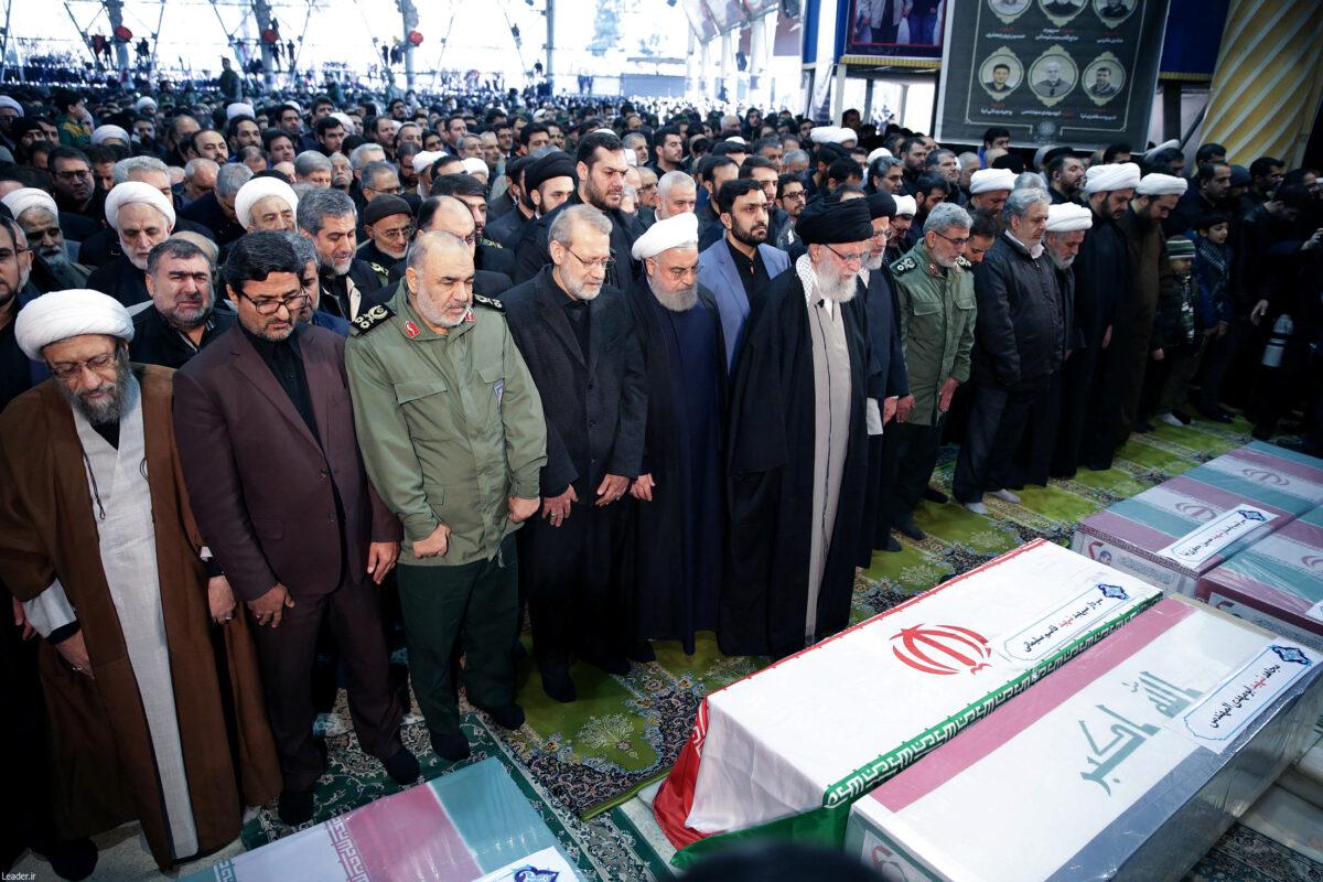 Iran's Supreme Leader Ayatollah Ali Khamenei and Iranian President Hassan Rouhani pray near the coffins of Iranian Major-General Qassem Soleimani, head of the elite Quds Force, and Iraqi militia commander Abu Mahdi al-Muhandis, who were killed in an airstrike at Baghdad airport, in Tehran, Iran, on Jan. 6, 2020. (Official President's Website/Handout via Reuters)