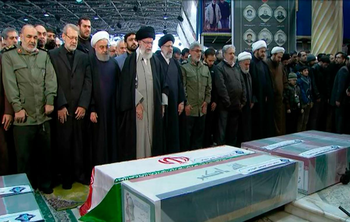 In this photo released by the official website of the Office of the Iranian Supreme Leader, supreme leader Ayatollah Ali Khamenei, front row, fourth from left, leads a prayer over the coffins of Gen. Qassem Soleimani and his comrades, who were killed in Iraq in a U.S. drone strike at the Tehran University campus, in Tehran, Iran, on Jan. 6, 2020. (Office of the Iranian Supreme Leader via AP, File)
