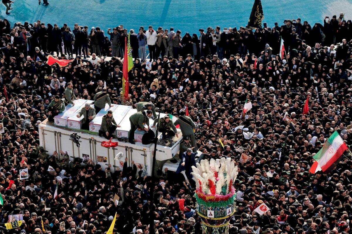 Coffins of Gen. Qassem Soleimani and others who were killed in Iraq by a U.S. drone strike are carried on a truck surrounded by mourners during a funeral procession at the Enqelab-e-Eslami (Islamic Revolution) square in Tehran, Iran, on Jan. 6, 2020. (Ebrahim Noroozi/AP Photo)