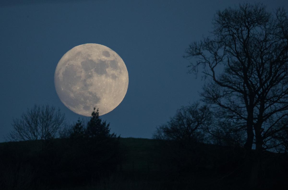 A Wolf Moon rises over Glastonbury Tor in Somerset, England, on Jan. 11, 2017. (©Getty Images | <a href="https://www.gettyimages.com/detail/news-photo/so-called-wolf-moon-rises-over-glastonbury-tor-on-january-news-photo/631486582?adppopup=true">Matt Cardy</a>)