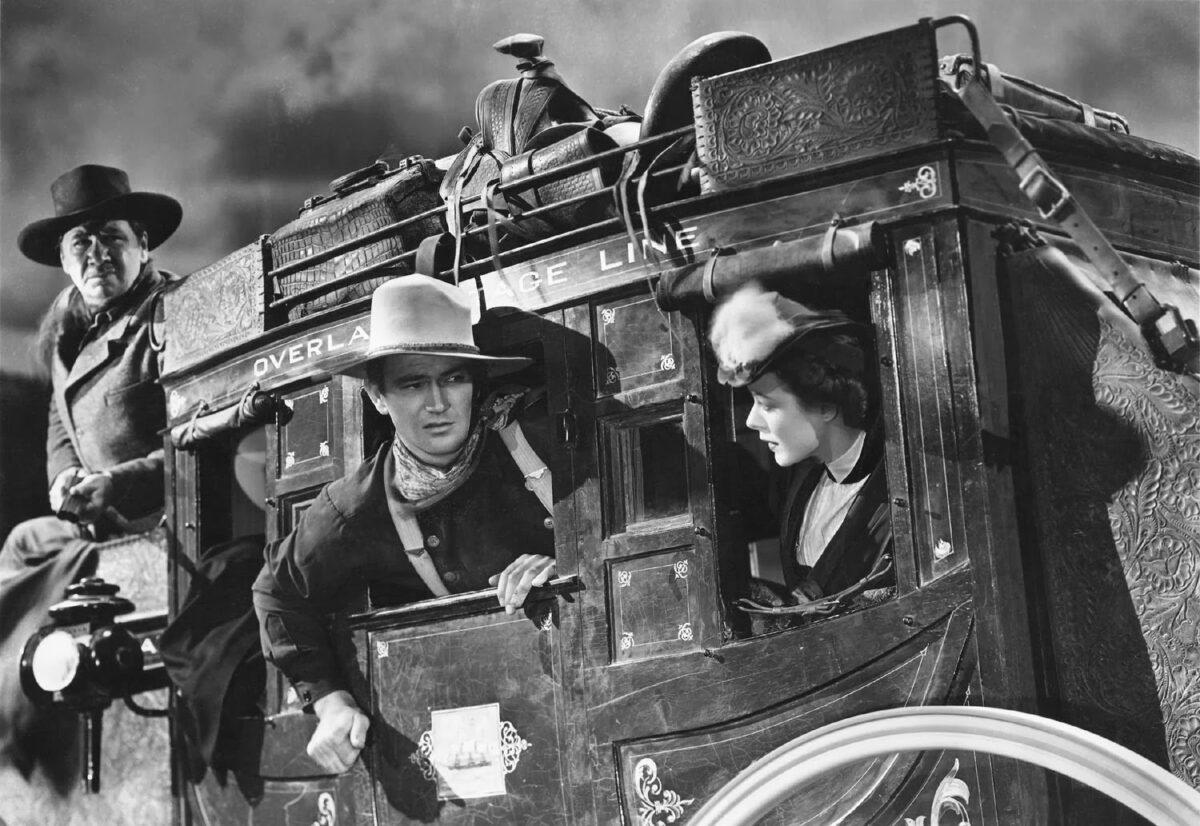 (L–R) George Bancroft, John Wayne, and Louise Platt in 1939's "Stagecoach," directed by John Ford. (Public Domain)