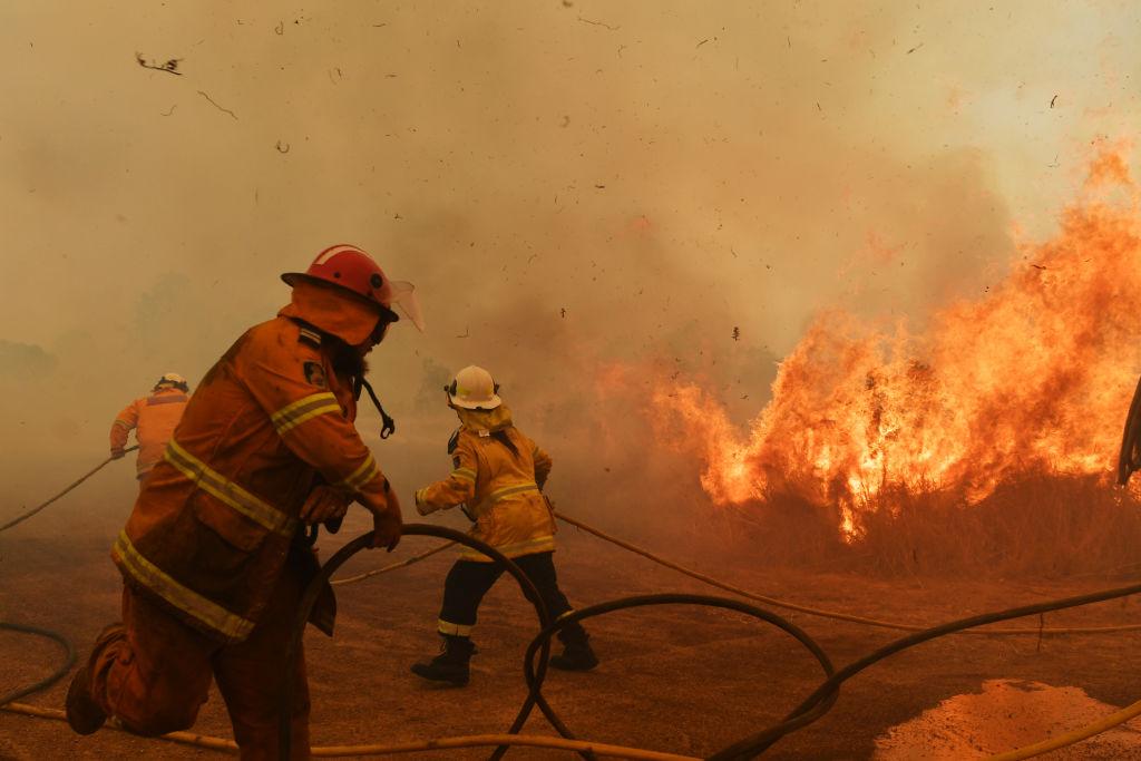 Firefighters battle a raging spot fire in Hillville, Australia, on Nov. 13, 2019. (©Getty Images | <a href="https://www.gettyimages.com/detail/news-photo/firefighters-battle-a-spot-fire-on-november-13-2019-in-news-photo/1187285611?adppopup=true">Sam Mooy</a>)