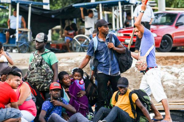 A group of 10 Haitians illegally cross the Suchiate River on a tube raft from Tecun Uman, Guatemala, to Hidalgo City, Mexico, on June 28, 2019. (Charlotte Cuthbertson/The Epoch Times)