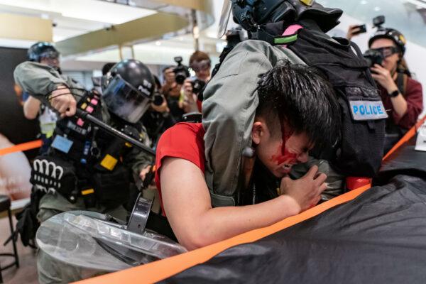 A man is detained by riot police during a demonstration in a shopping mall at Sheung Shui district in Hong Kong, China, on Dec. 28, 2019. (Anthony Kwan/Getty Images)