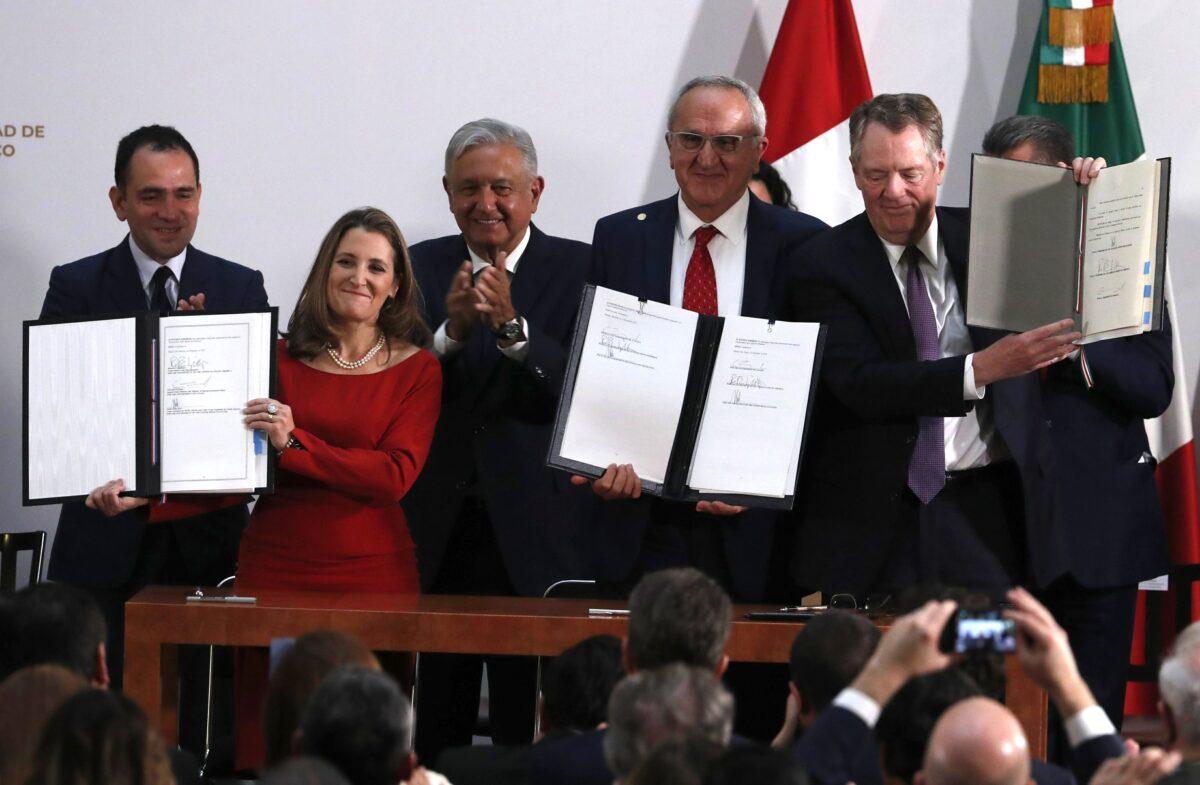 Mexico's Treasury Secretary Arturo Herrera, left, Deputy Prime Minister of Canada Chrystia Freeland, second left, Mexico's President Andres Manuel Lopez Obrador, center, Mexico's top trade negotiator Jesus Seade, second right, and U.S. Trade Representative Robert Lighthizer, hold the documents after signing an update to the North American Free Trade Agreement, at the national palace in Mexico City, on Dec. 10. 2019. (Marco Ugarte/AP Photo)