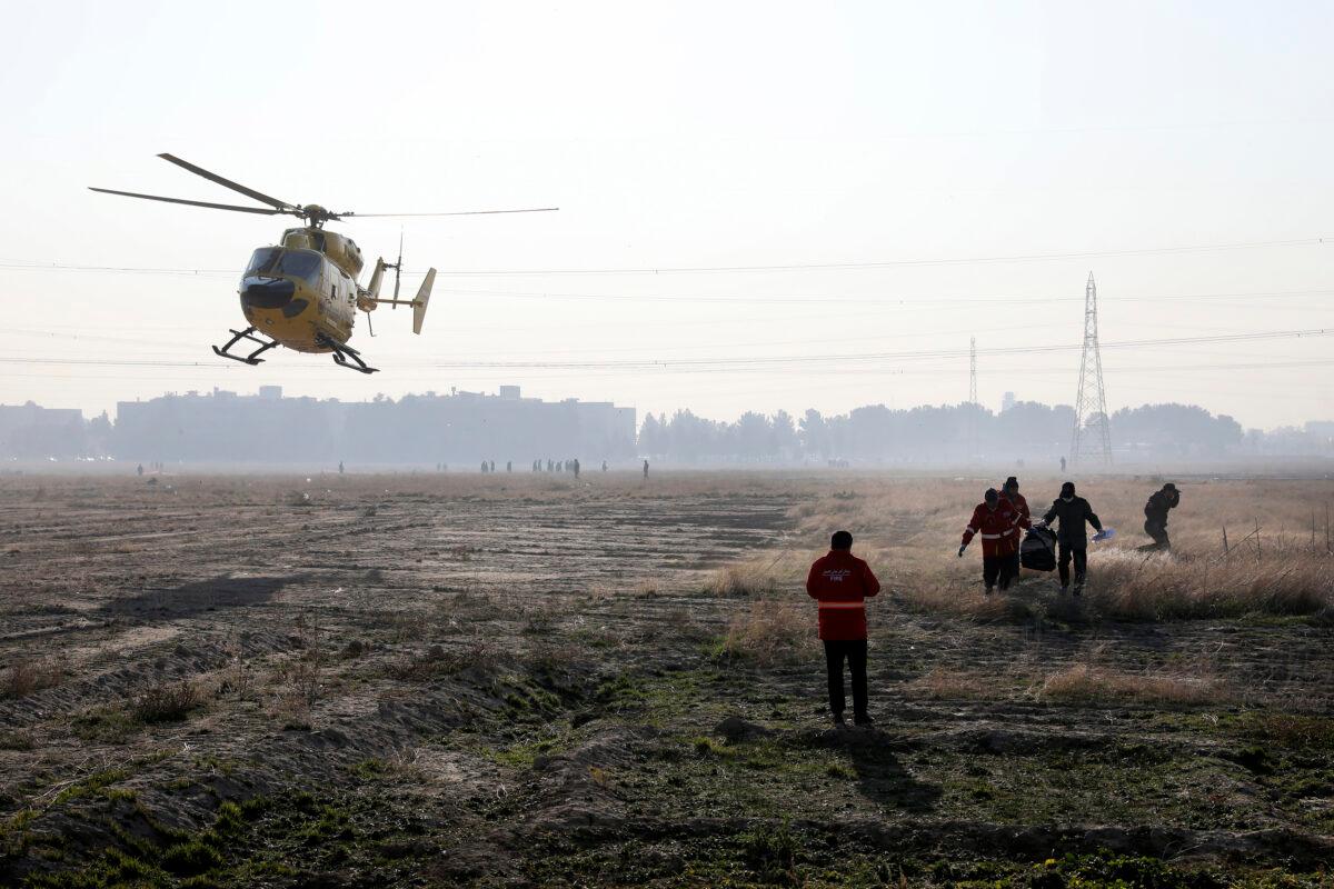 Rescue teams work at the scene where a Ukrainian plane crashed in Shahedshahr, southwest of the capital Tehran, Iran, on Jan. 8, 2020. (Ebrahim Noroozi/AP Photo)