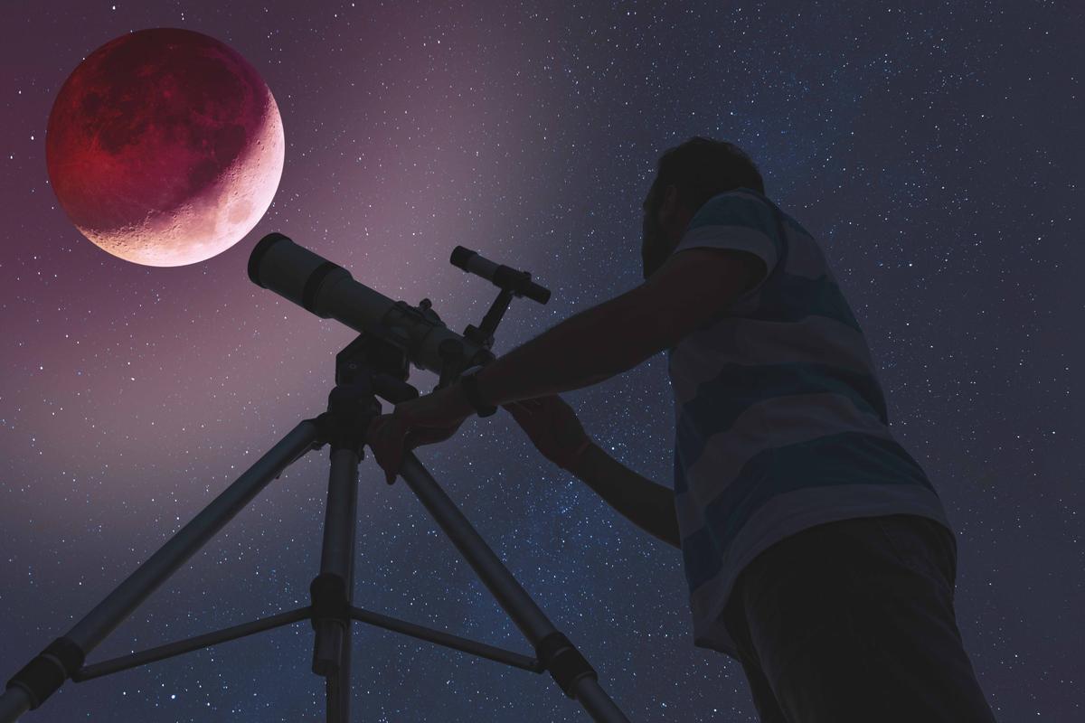 Illustration - Shutterstock | <a href="https://www.shutterstock.com/image-photo/man-looking-lunar-eclipse-through-telescope-1137719060">AstroStar</a>