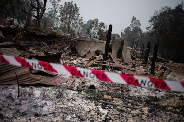 A cordon tape with the word "Danger" is seen in front of a burnt down shop in the village of Mogo, Australia on Jan. 8, 2020. (Alkis Konstantinidis/Reuters)