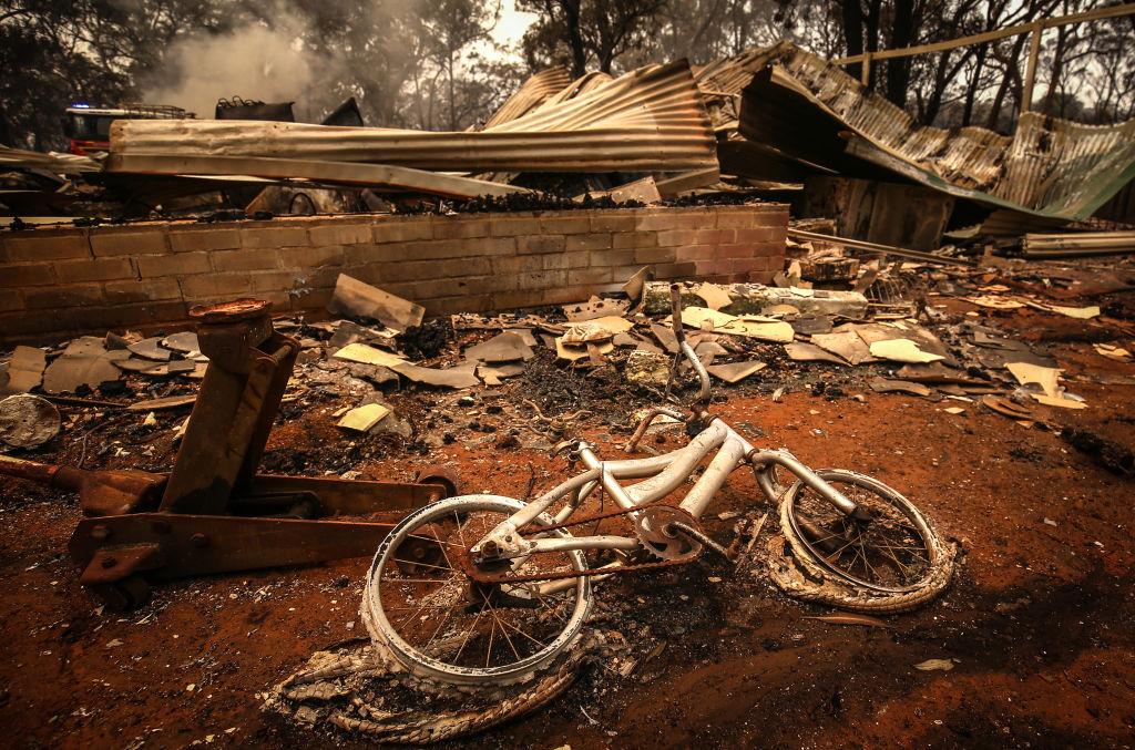 A burnt bicycle lies on the ground in front of a house recently destroyed by wildfires on the outskirts of the town of Bargo in Sydney, Australia, on Dec. 21, 2019. (David Gray/Getty Images)