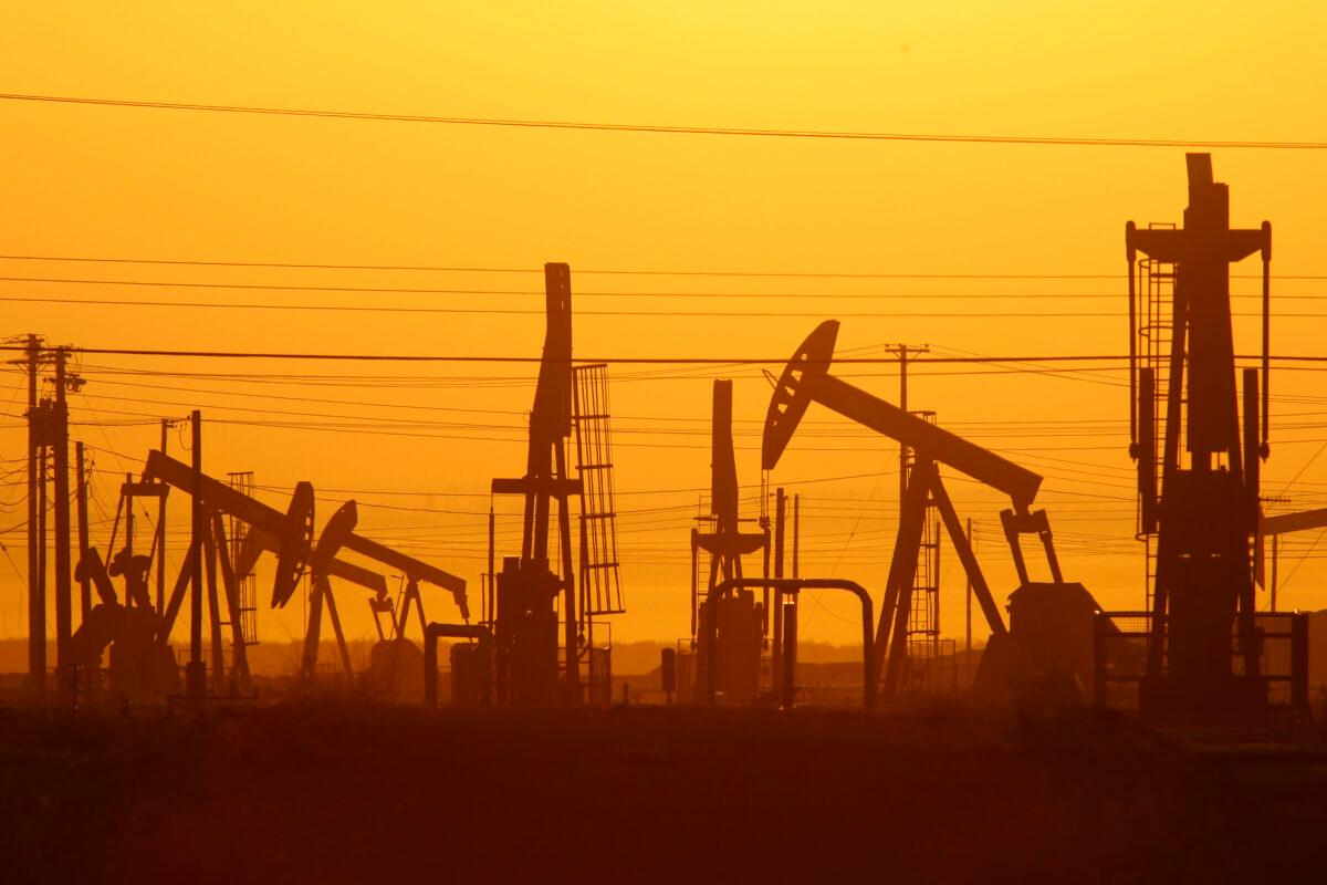Pump jacks are seen at dawn in an oil field over the Monterey Shale formation near Lost Hills, Calif., on March 24, 2014. (David McNew/Getty Images)