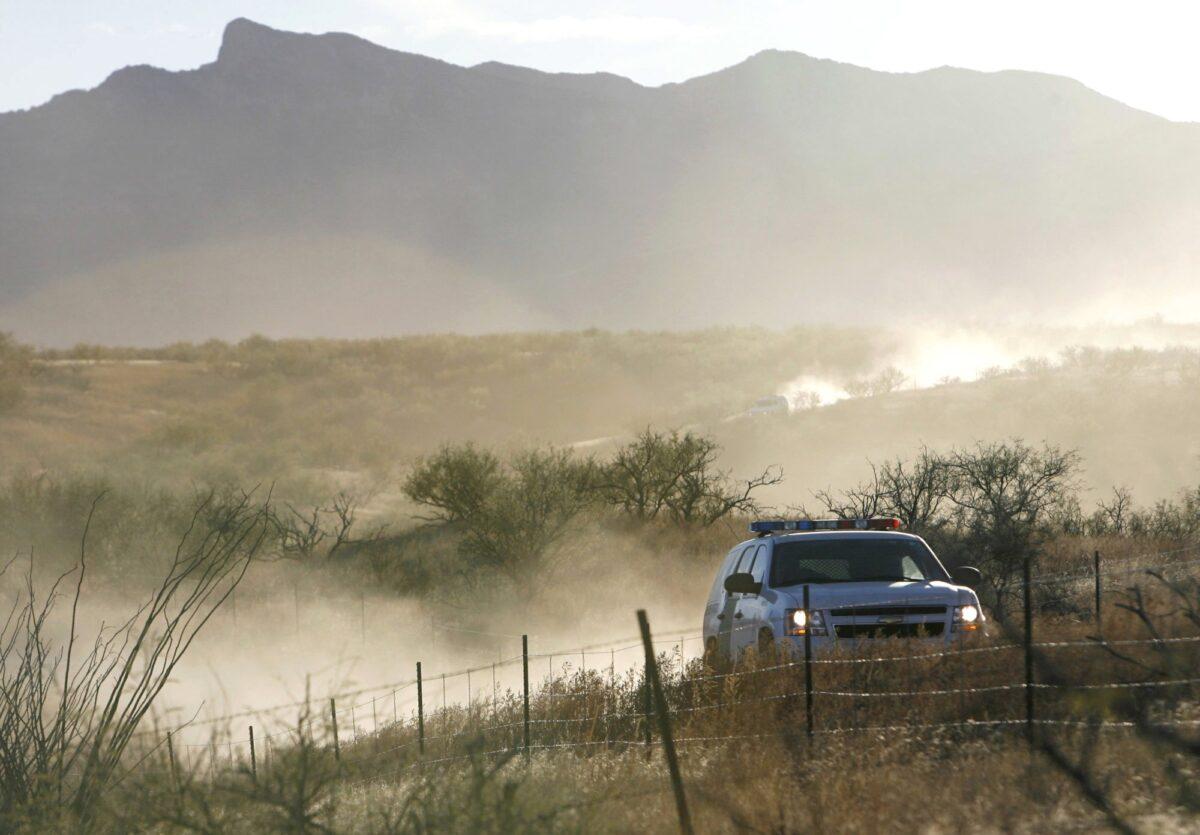 A U.S. Border Patrol vehicle returns on Dec. 15, 2010, from the scene of an overnight shootout where Border Patrol Agent Brian Terry was killed northwest of Nogales, Ariz. (Greg Bryan/Arizona Daily Star via AP)
