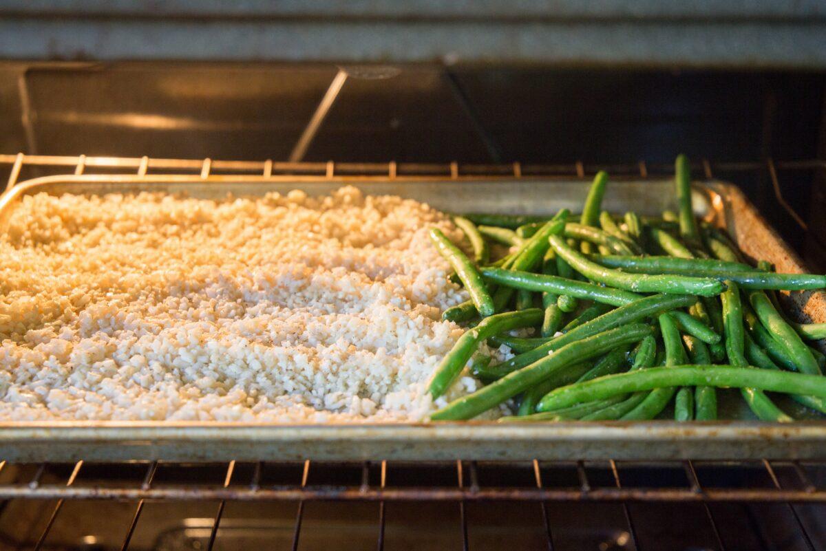 The cauliflower rice and green beans roast side by side. (Caroline Chambers)