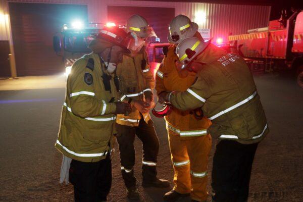 Firefighters at Burragate, Australia, gather outside the firehouse as they discuss a nearby fire threat on Jan. 10, 2020. (Rick Rycroft/AP Photo)
