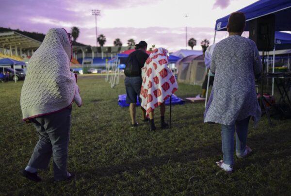 People get up after spending the night in a baseball stadium amid aftershocks and without electricity after the 6.4 magnitude earthquake in Guayanilla, Puerto Rico, at sunrise, on Jan. 10, 2020. (Carlos Giusti/AP Photo)