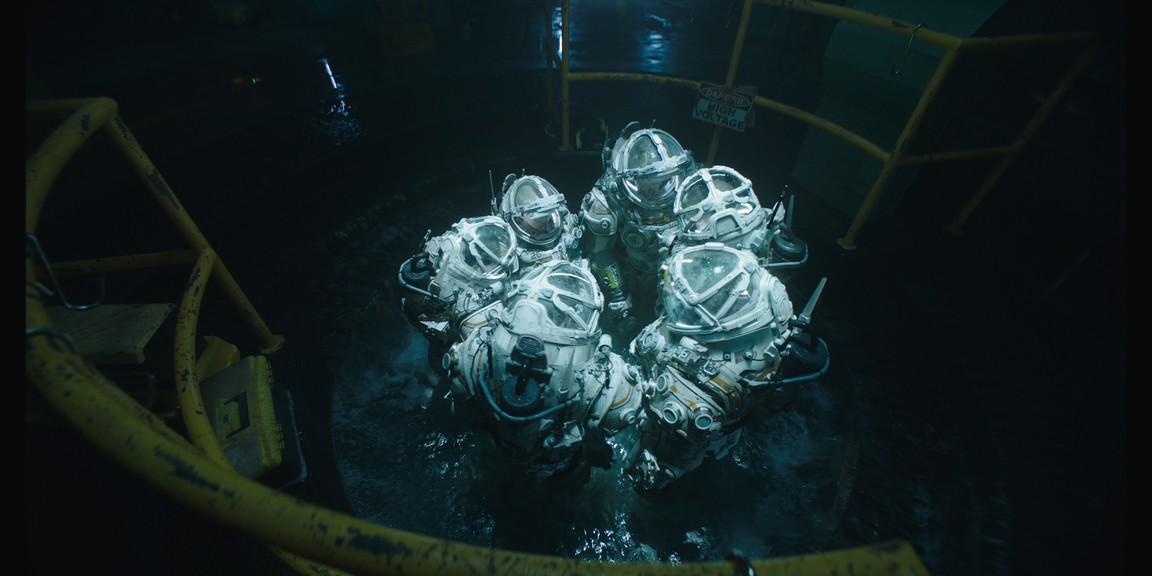 In space-like underwater gear, the crew heads out in "Underwater." (20th Century Fox)