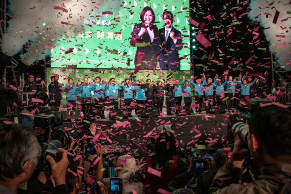 Confetti falls as Tsai Ing-wen (C) stands with Vice President-elect William Lai (C-L) and Vice-President, Chen Chien-jen (C-R), as she celebrates after addressing supporters following her reelection as President of Taiwan in Taipei, Taiwan, on Jan. 11, 2020. (Carl Court/Getty Images)